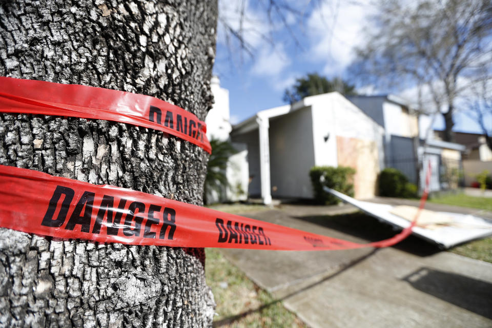 Red "danger" tape circles a damaged home on Bridgeland Lane in Houston, Sunday, Jan. 26, 2020, after the Watson Grinding Manufacturing explosion early Friday morning. (Karen Warren/Houston Chronicle via AP)