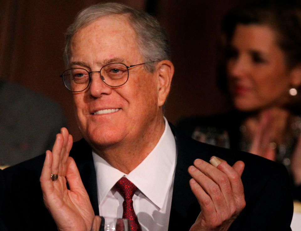 David Koch, executive vice president of Koch Industries, applauds during an Economic Club of New York event in New York, December 10, 2012.  REUTERS/Brendan McDermid/File Photo - RC1FF78C3D30