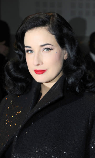 Dita Von Teese added red lipstick to her all-black outfit for the Elie Saab SS13 couture show © Rex