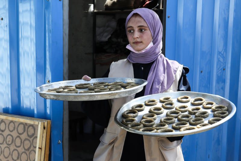 Palestinian women prepare traditional biscuits (Eid Cakes) popular on the occasion of Eid al-Fitr at Displaced Persons' Shelter Center in the shadow of Israeli attacks in the Gaza Strip, in Rafah, southern Gaza. Muslims around the world are celebrating the Eid al-Fitr holiday, which marks the end of the fasting month of Ramadan. Photo by Ismael Mohamad/UPI