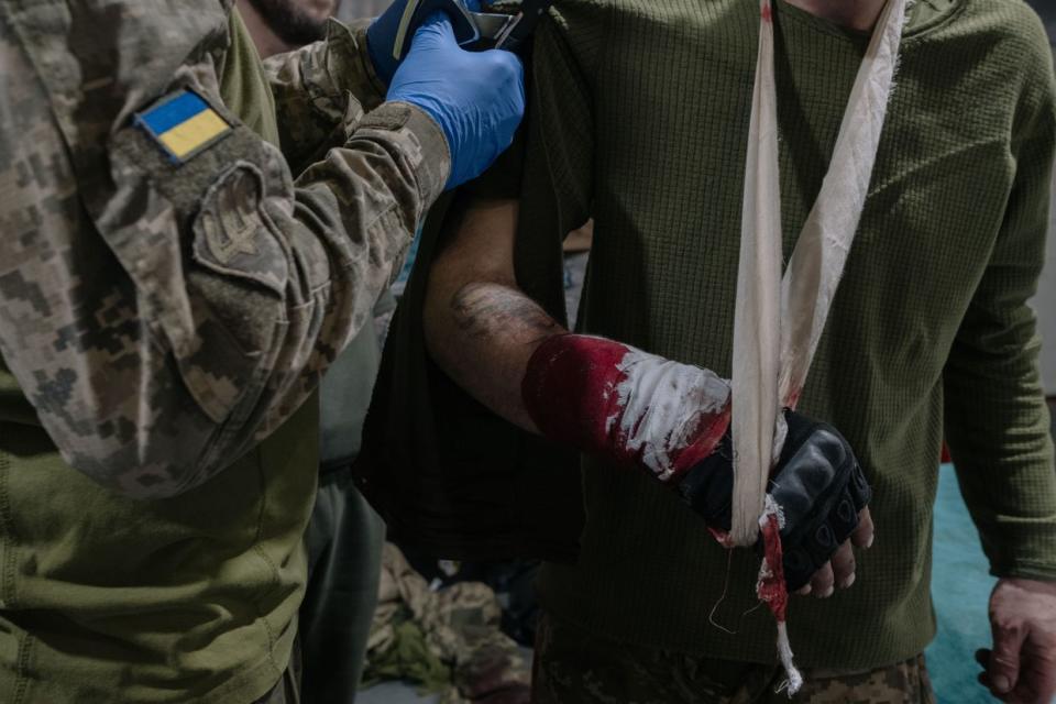 Ukrainian military medics tend to a wounded soldier at a stabilization point near Chasiv Yar, Donetsk Oblast, on April 25, 2024. (Francis Farrell/The Kyiv Independent)