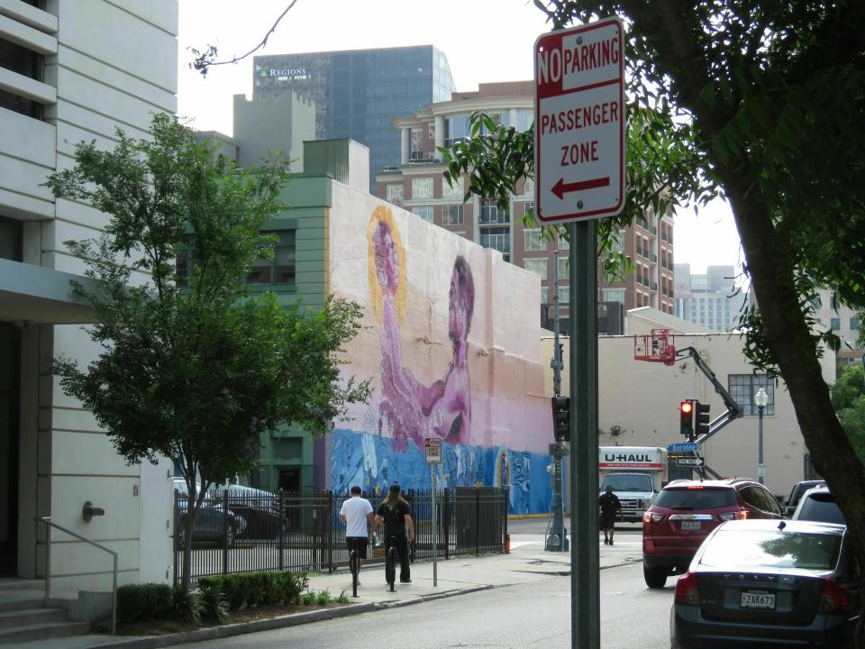 In this May 31, 2019 photo, This mural, is among five created for the Arts Council of New Orleans "Unframed:" project. The council's executive director, Heidi Schmalbach, says the group wanted to bring the city's vibrant art scene outside gallery walls. All five murals are in a walkable distance of each other. (AP Photo/Janet McConnaughey)
