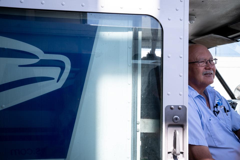 A portrait of Joe Willers, a letter carrier, in his truck on June 7, 2023, at the USPS Washington Station in Phoenix.