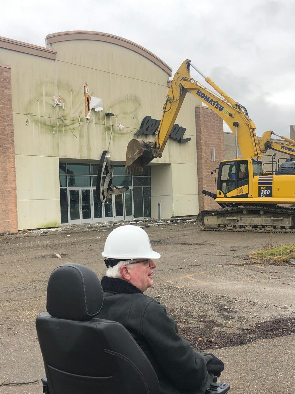 In December 2022, Mayor Alan Andreani and others watch excavators ceremoniously tear down some of the old Carnation City Mall. A new retail plaza with a Meijer superstore is under construction there.