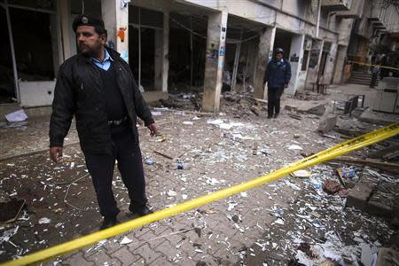 A policeman cordons off the site of a bomb attack at the district court in Islamabad March 3, 2014. REUTERS/Zohra Bensemra