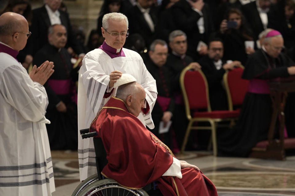 Pope Francis arrives to celebrate the Passion Mass on Good Friday, inside St. Peter's Basilica, at the Vatican, Friday, April 7, 2023. (AP Photo/Andrew Medichini)