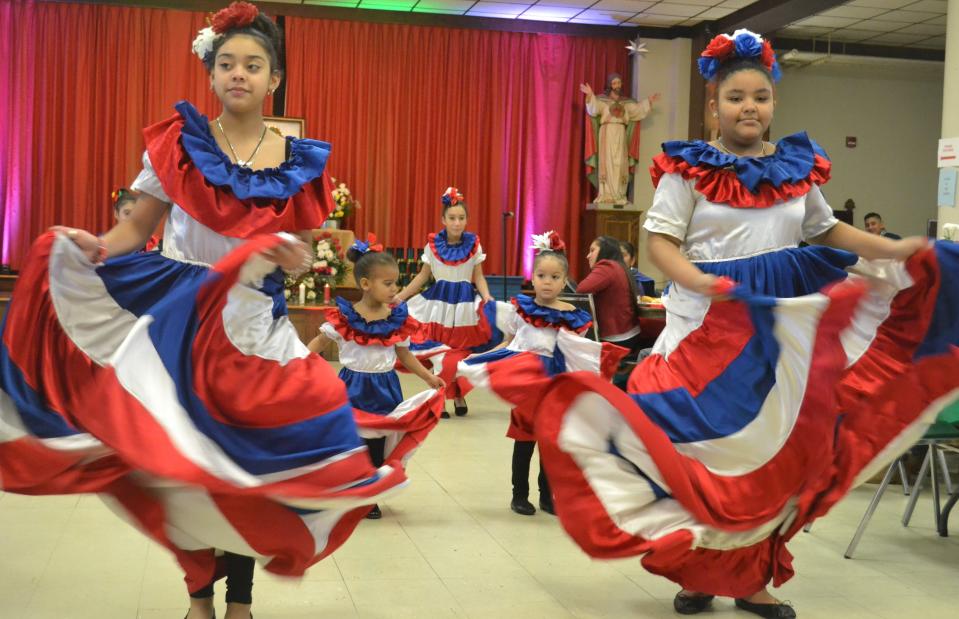 Dancers from the Providence-based Grupo Arcoiris wore dresses in the colors of the Dominican flag and performed traditional Dominican dances in the basement of St. Joseph's Church in Newport at the Feast Day of Our Lady of Guadalupe on Sunday Dec. 18, 2022.