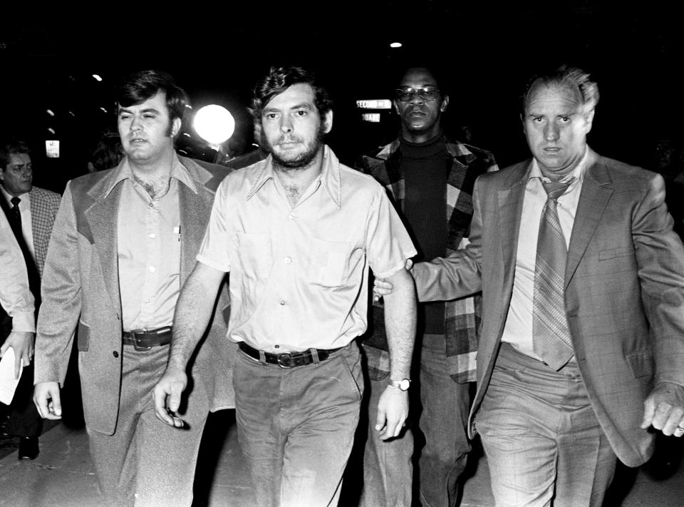 Metro Detective Sgt. Sherman Nickens, right, escorts Douglas Brown, middle, 21, of Greenbrier, Tenn., to the detective division Nov. 14, 1973. Brown, along with his brother, Roy, was interrogated for several hours about the murders of David (Stringbean) Akeman and his wife, Estelle. They were released from police custody and no charges were placed against the brothers.