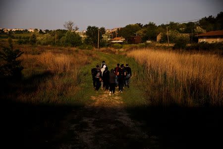 A group of Syrian refugees who crossed the Evros river, the natural border between Greece and Turkey, walks towards the city of Didymoteicho, Greece, April 30, 2018. Picture taken April 30, 2018. REUTERS/Alkis Konstantinidis