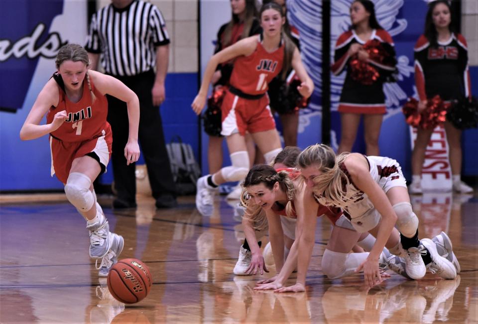 Jim Ned's Emma Doran, left, eyes a loose ball while a teammate also battles a Ballinger player for the ball.