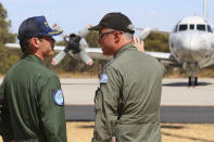Commander Hidetsugu Iwamasa, left, of the Japan Maritime Self-Defense Force talks with Royal Australian Air Force Group Commander Craig Heath before a Japanese P-3C Orion's departure from the RAAF Pearce Base to commence a search for possible debris from the missing Malaysia Airlines flight MH370, in Perth, Australia, Monday, March 24, 2014. Satellite images released by Australia and China had earlier identified possible debris in an area that may be linked to the disappearance of the flight on March 8 with 239 people aboard. (AP Photo/Paul Kane, Pool)