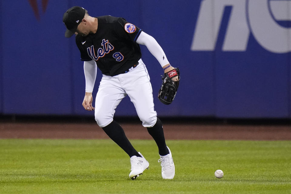 New York Mets right fielder Brandon Nimmo loses control of the ball hit by Atlanta Braves' Eddie Rosario for a three-run single during the fourth inning of a baseball game Friday, Aug. 11, 2023, in New York. Rosario advanced to second base on a fielding error by Nimmo. (AP Photo/Frank Franklin II)