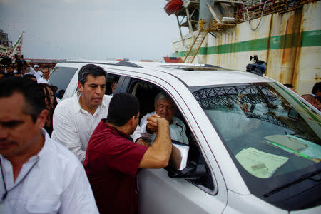 Mexico's new President Andres Manuel Lopez Obrador interacts with a supporter after an event to unveil his plan for oil refining, in Paraiso, Tabasco state, Mexico, December 9, 2018. Picture taken December 9, 2018. REUTERS/Alexandre Meneghini