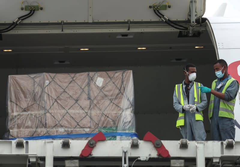 Ethiopian Airlines workers unload a consignment of medical donation from Chinese billionaire Jack Ma and Alibaba Foundation to Africa in Addis Ababa