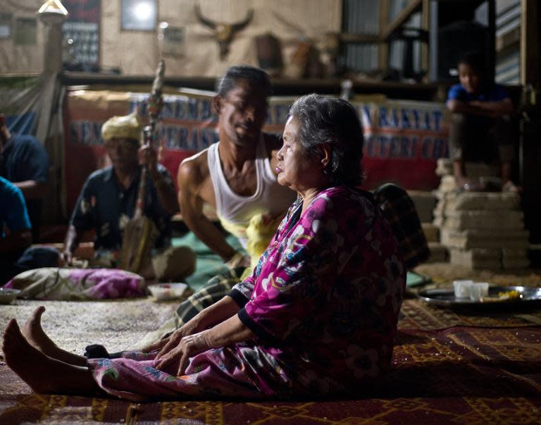 A Malaysian shaman performs "main puteri" treatment on a patient at a village in Tanah Merah, June 8, 2014