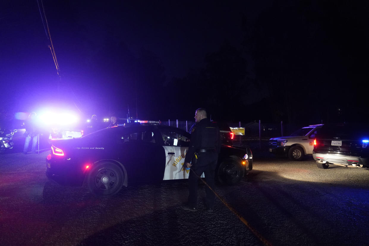 Law enforcement personnel control the scene of a shooting Monday, Jan. 23, 2023, in Half Moon Bay, Calif. Multiple people were killed in two related shootings Monday at a mushroom farm and a trucking firm in a coastal community south of San Francisco, and officials say a suspect is in custody. (AP Photo/Jeff Chiu)