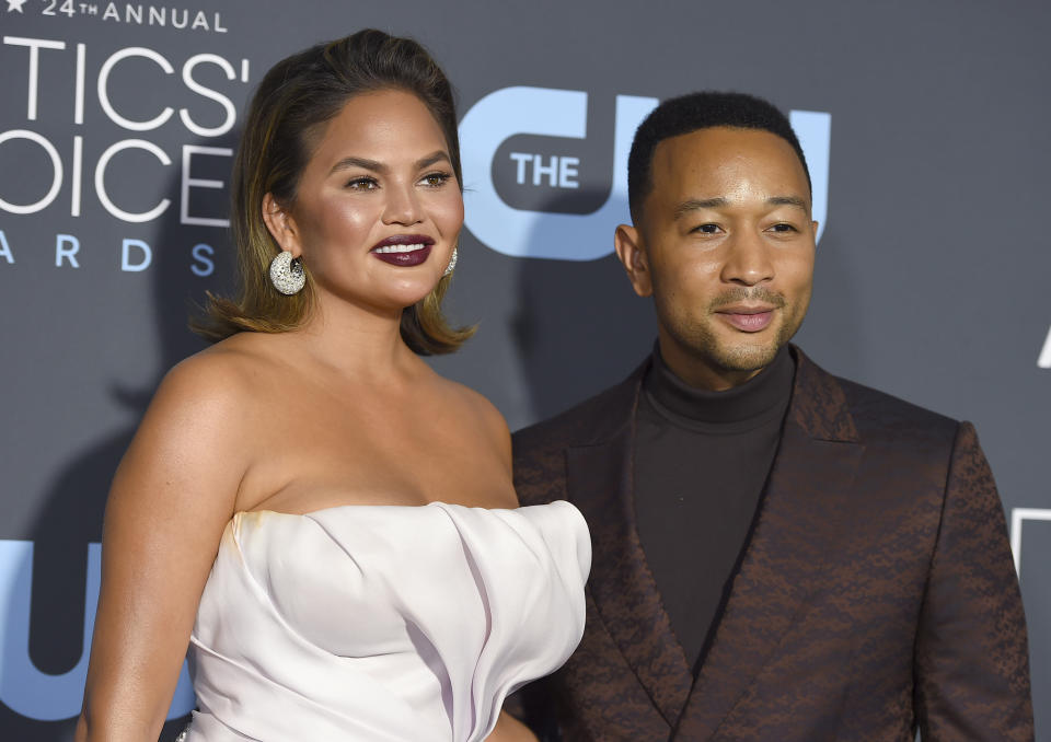 FILE - In this Jan. 13, 2019 file photo, Chrissy Teigen, left, and John Legend arrive at the 24th annual Critics' Choice Awards at the Barker Hangar in Santa Monica, Calif. President Donald Trump targeted the couple following an MSNBC special on criminal justice reform which Legend appeared on. In a series of tweets late Sunday, Sept. 8 and early Monday, Sept. 9 Trump felt he wasn’t getting credit for a law he signed in late December that, among other things, reduces mandatory minimum sentences in some cases. Trump called Legend “boring” and said Teigen was “filthy mouthed.” He criticized them for not playing a role in the reform. (Photo by Jordan Strauss/Invision/AP, File)