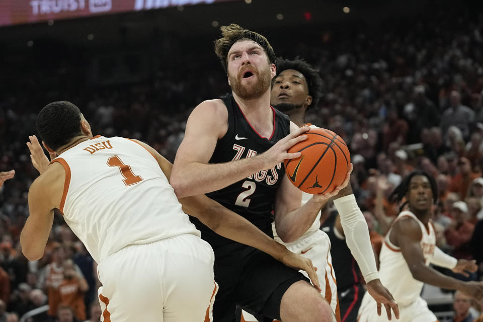 Gonzaga forward Drew Timme (2) drives to the basket against Texas forward Dylan Disu (1) during the first half of an NCAA college basketball game, Wednesday, Nov. 16, 2022, in Austin, Texas. (AP Photo/Eric Gay)