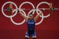 Hidilyn Diaz of Philippines competes in the women's 55kg weightlifting event, at the 2020 Summer Olympics, Monday, July 26, 2021, in Tokyo, Japan. (AP Photo/Luca Bruno)