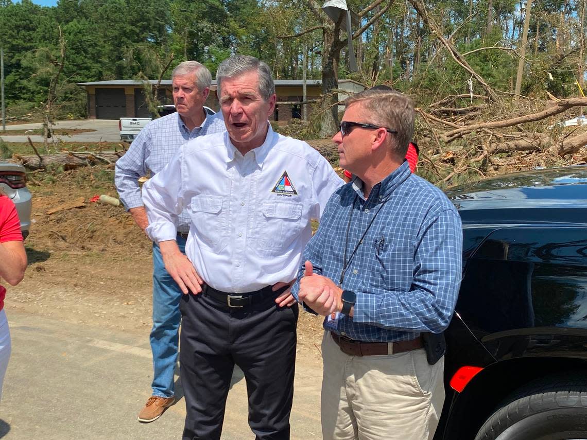 Gov. Roy Cooper tours tornado-damaged houses across from Dortches Town Hall with Nash County Emergency Management Director Tony Cameron.