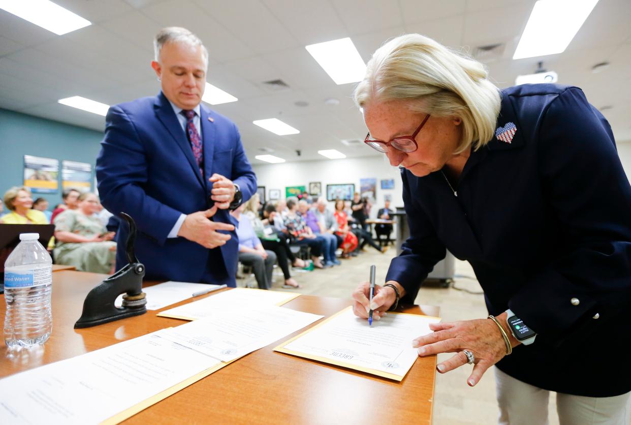 Judy Brunner, who signed paperwork after being sworn in to serve on the Springfield school board, won the most votes and raised the most money in the campaign.