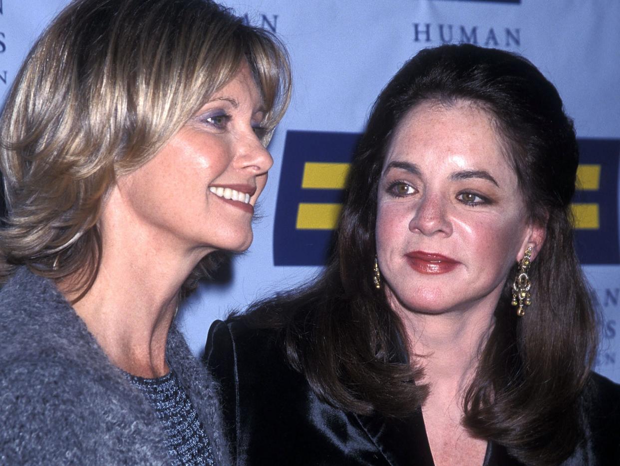 Olivia Newton-John and Stockard Channing pose for photos in 2001.