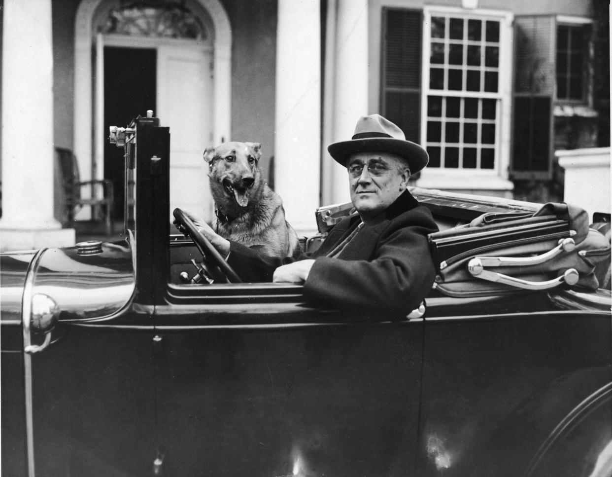 Portrait of American President Franklin Delano Roosevelt behind the wheel of his car outside his home in Hyde Park, New York, mid 1930s. (Getty Images)