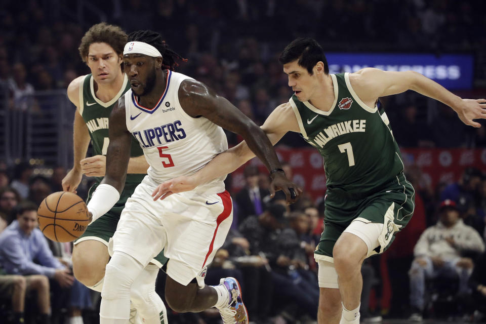 Los Angeles Clippers' Montrezl Harrell (5) dribbles past Milwaukee Bucks' Ersan Ilyasova (7) during the first half of an NBA basketball game Wednesday, Nov. 6, 2019, in Los Angeles. (AP Photo/Marcio Jose Sanchez)