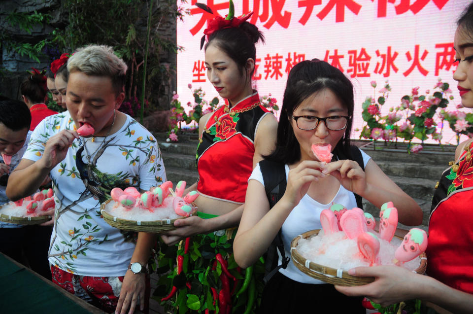 Tourists compete eating pepper ice-creams at Song Dynasty Town on July 20, 2016 in Hangzhou, Zhejiang Province of China.&nbsp;