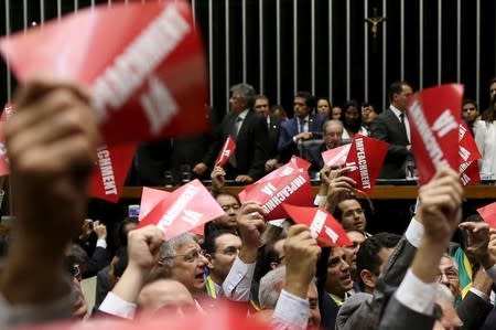 Opposition deputies hold papers that read, " Impeachment now!" during ballot to appoint a committee to report on whether to impeach Brazil's President Dilma Rousseff at the National Congress in Brasilia, Brazil, March 17, 2016. REUTERS/Adriano Machado