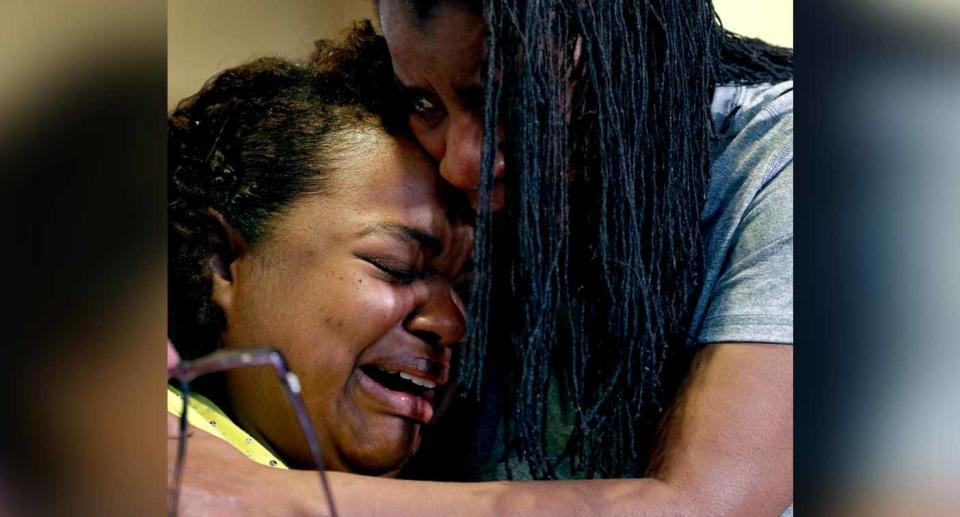 Tia Coleman is comforted by her sister Leeta Bigbee after speaking to the media on Saturday. Source: AP via AAP