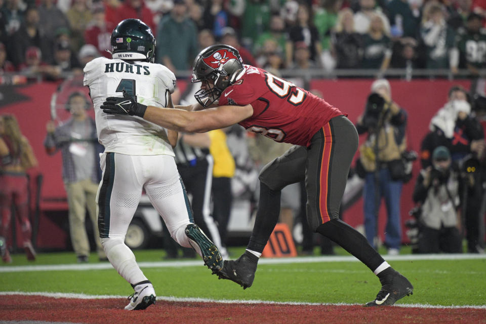 Tampa Bay Buccaneers linebacker Anthony Nelson, right, forces a safety on Philadelphia Eagles quarterback Jalen Hurts during the second half of an NFL wild-card playoff football game, Monday, Jan. 15, 2024, in Tampa, Fla. (AP Photo/Phelan M. Ebenhack)