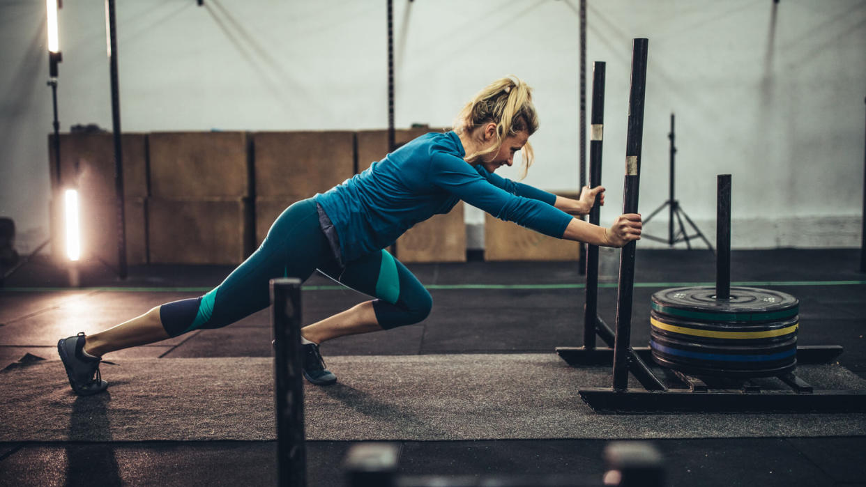 Woman exercising with weights in the gym.