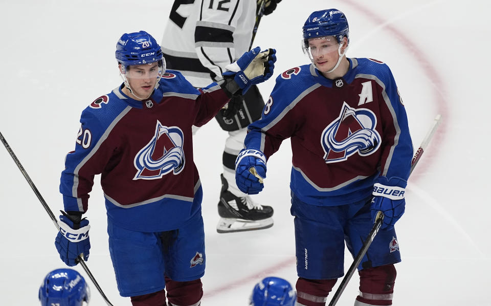 Colorado Avalanche center Ross Colton, left, is congratulated by defenseman Cale Makar for a goal against the Los Angeles Kings during the third period of an NHL hockey game Friday, Jan. 26, 2024, in Denver. (AP Photo/David Zalubowski)