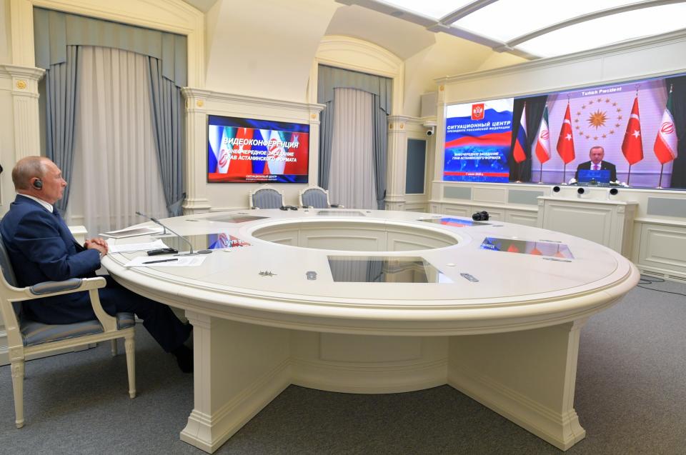 Russian President Vladimir Putin, left, attends a video conference with Turkish President Recep Tayyip Erdogan and Iranian President Hassan Rouhani in Moscow, Russia, Wednesday, July 1, 2020. The three leaders discussed the situation in Syria and ways to promote a political settlement. (Alexei Druzhinin, Sputnik, Kremlin Pool Photo via AP)