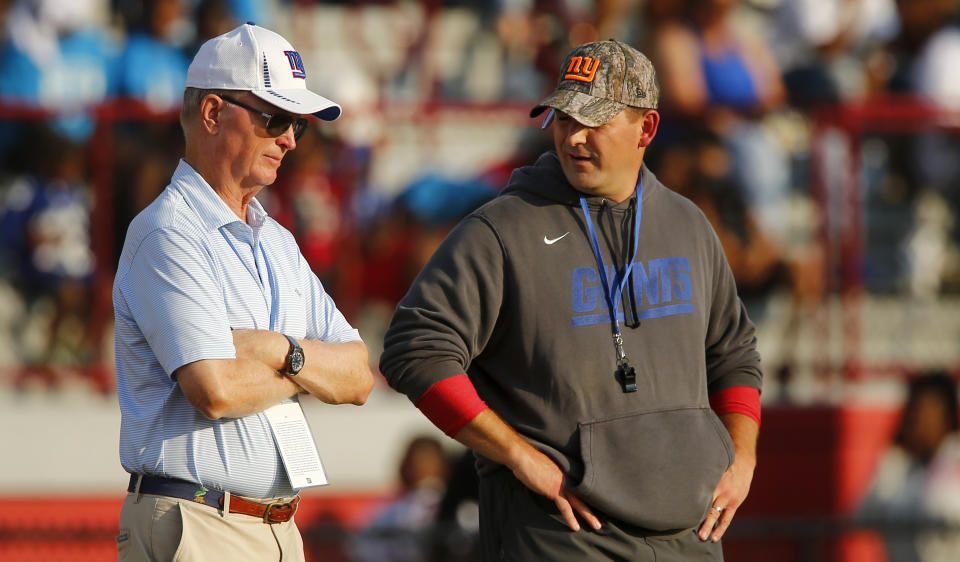 New York Giants coach Joe Judge, right, and team president John Mara talk during the NFL football team's training camp practice at Eddie Moraes Stadium, Saturday, July 31, 2021, in Newark, N.J. (AP Photo/John Munson)