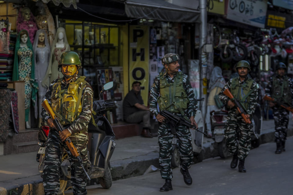 Indian paramilitary soldiers patrol at a busy market in Srinagar, Indian controlled Kashmir, Tuesday, Aug 1, 2023. India’s top court Wednesday began hearing a clutch of petitions challenging the constitutionality of the legislation passed by Prime Minister Narendra Modi’s government in 2019 that stripped disputed Jammu and Kashmir’s statehood, scrapped its separate constitution and removed inherited protections on land and jobs. (AP Photo/Mukhtar Khan)