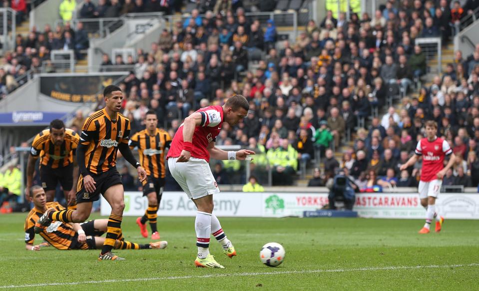 Arsenal's Lukas Podolski scores his side's third goal during their English Premier League soccer match against Hull City at The KC Stadium, Hull, England, Sunday, April 20, 2014. (AP Photo/Lynne Cameron, PA Wire) UNITED KINGDOM OUT - NO SALES - NO ARCHIVES