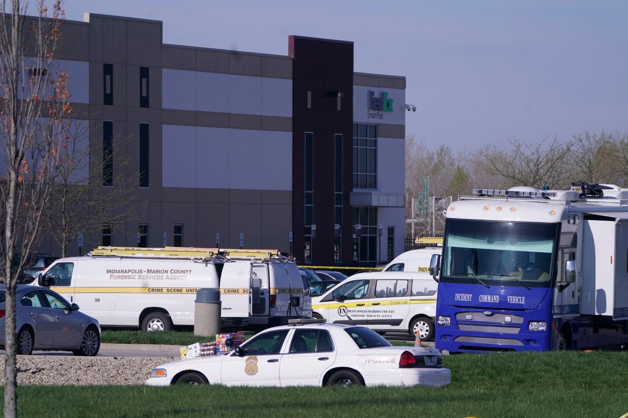 Vehicles are parked at the scene where multiple people were shot at the FedEx Ground facility early Friday morning, April 16, 2021, in Indianapolis.