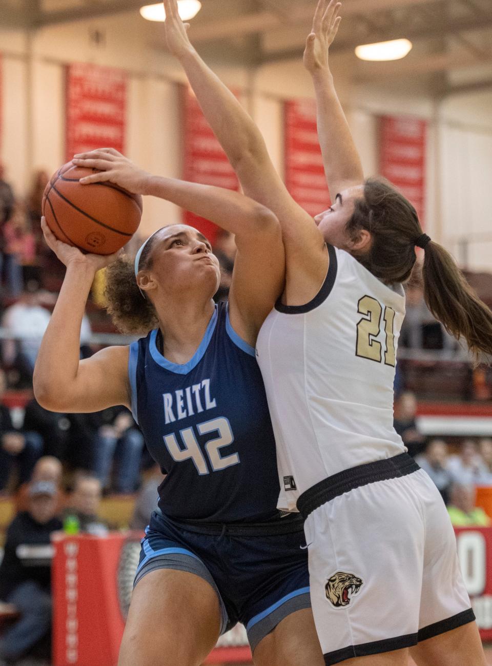 Reitz’s Kaelyse Mitchell (42) takes a shot against Jasper’s Emma Schipp (21) as the Reitz Panthers play the Jasper Wildcats during the semifinal round of the 2023 IHSAA Class 4A Girls Basketball Sectional at Harrison High School in Evansville, Ind., Friday, Feb. 3, 2023.