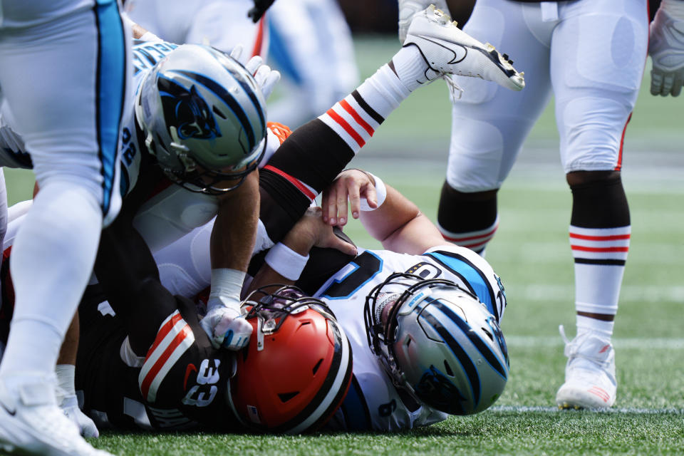 Carolina Panthers quarterback Baker Mayfield is sacked by Cleveland Browns safety Ronnie Harrison Jr. during the first half of an NFL football game on Sunday, Sept. 11, 2022, in Charlotte, N.C. (AP Photo/Jacob Kupferman)
