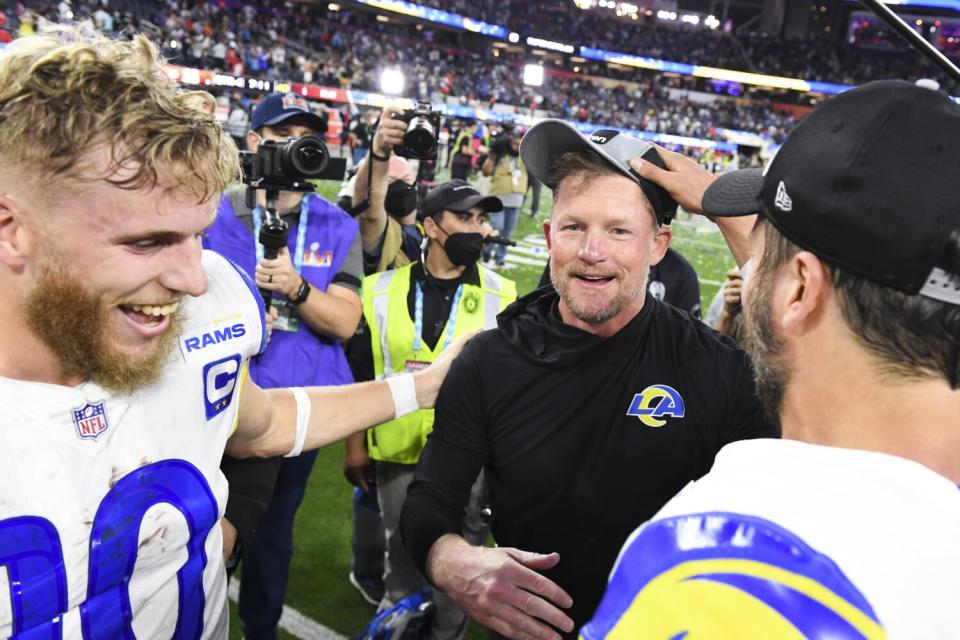 Rams general manager Les Snead, center, celebrates with receiver Cooper Kupp, left, and quarterback Matthew Stafford.