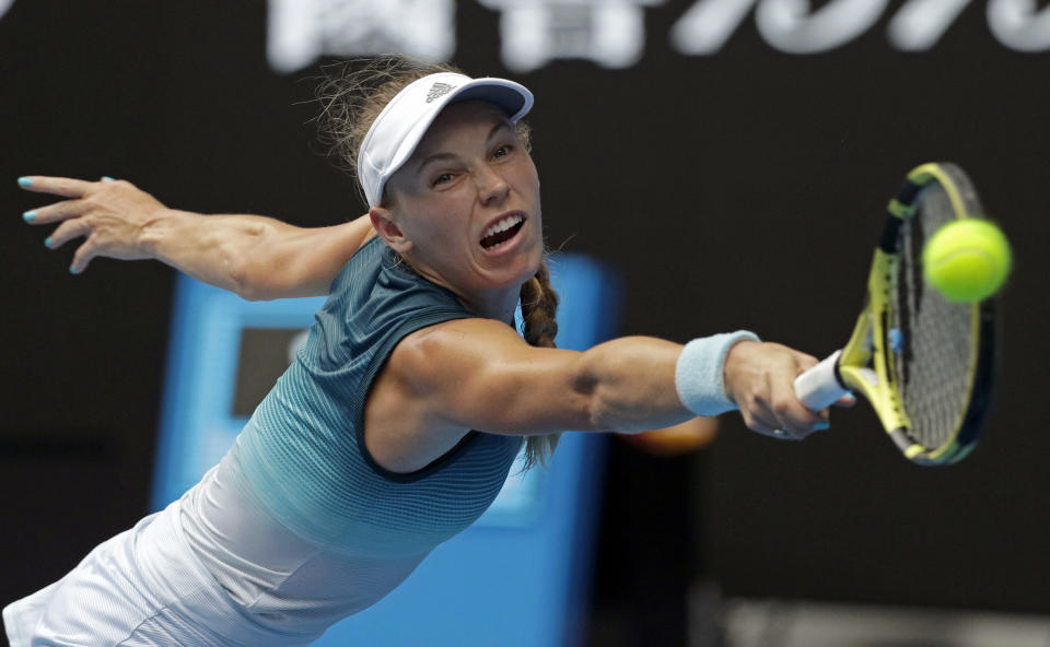 FILE - Denmark's Caroline Wozniacki makes a backhand return to Russia's Maria Sharapova during their third round match at the Australian Open tennis championships in Melbourne, Australia, Friday, Jan. 18, 2019. Wozniacki, a former No. 1-ranked tennis player and the 2018 Australian Open champion, announced Thursday, June 29, 2023, that she is returning to competition three years after she retired. (AP Photo/Kin Cheung)