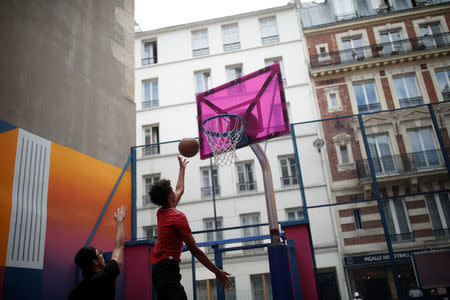 The basketball court Pigalle Duperre, painted in shades of purple, pink, yellow, orange and blue, and with a rubber-surfaced court, is sandwiched into a row of buildings in the 9th arrondissement, is pictured in Paris, France, July 31, 2018. REUTERS/Benoit Tessier