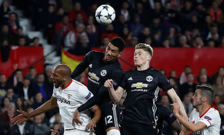 Soccer Football - Champions League Round of 16 First Leg - Sevilla vs Manchester United - Ramon Sanchez Pizjuan, Seville, Spain - February 21, 2018 Manchester United's Chris Smalling and Scott McTominay in action with Sevilla’s Steven N'Zonzi REUTERS/Juan Medina