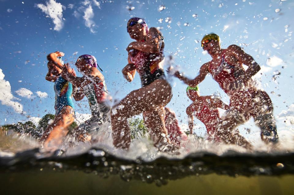 Hanne de Vet of Belgium, Maria Tome of Portugal, Anna Godoy Contreras of Spain, and Paulina Klimas of Poland compete in the swimming stage of the Women's Elite Triathlon competition during the European Championships Munich 2022 in Germany.