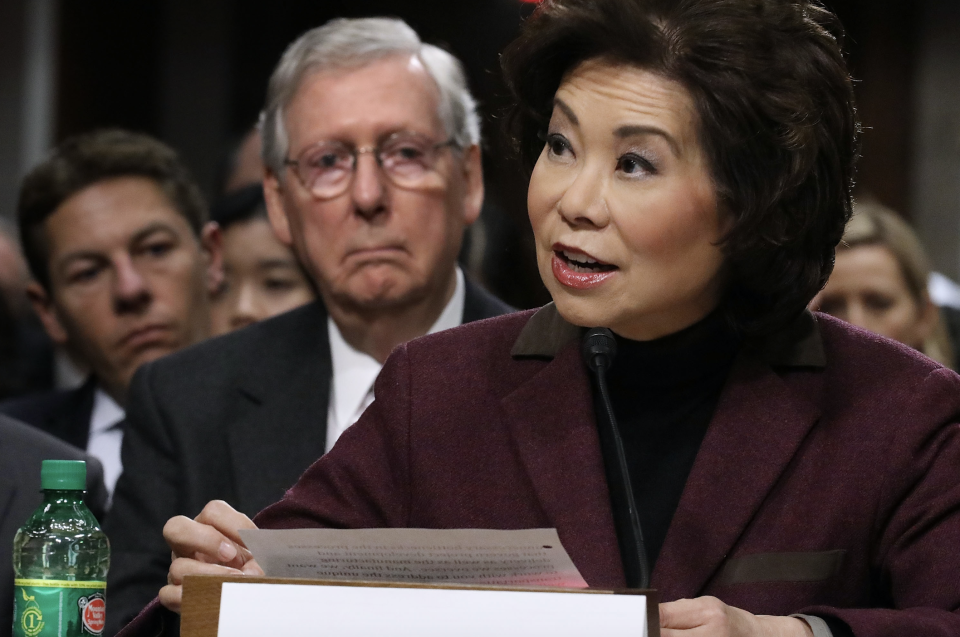 Elaine Chao testifies during her confirmation hearing to be the next U.S. secretary of transportation as her husband, Senate Majority Leader Mitch McConnell (R-KY) (2nd L) looks on, January 11, 2017 in Washington, DC. (Photo by Chip Somodevilla/Getty Images)