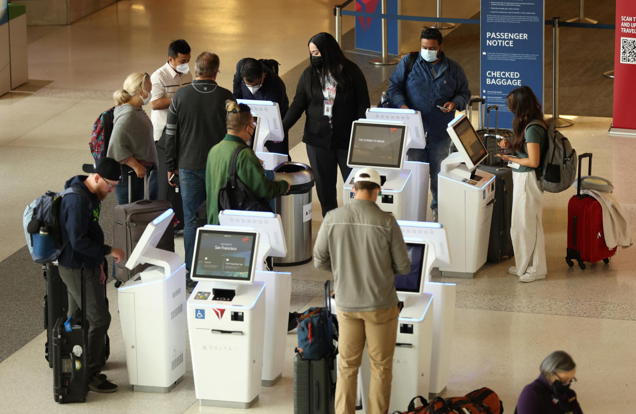 SAN FRANCISCO, CALIFORNIA - MAY 12: Delta Airlines customers check in for flights at San Francisco International Airport on May 12, 2022 in San Francisco, California. According to a report by the Bureau of Labor Statistics, airline fares surged 18.6% in April as demand for air travel has increased due to COVID-19-related travel restrictions being eased. (Photo by Justin Sullivan/Getty Images)