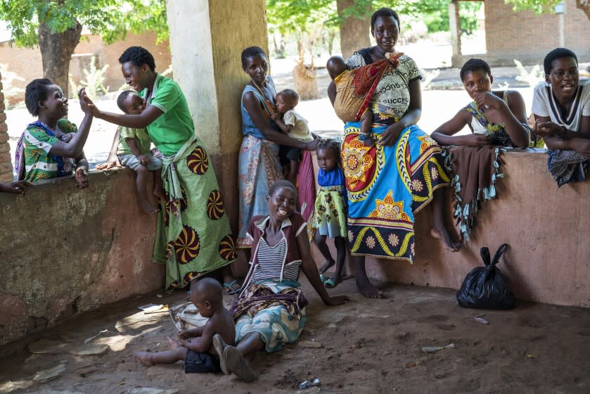 FILE - Residents of the Malawi village of Tomali wait to have their young children become test subjects for the world's first vaccine against malaria, on Wednesday, Dec. 11, 2019. Africa recorded a ten-year growth in its healthy life expectancy over the last ten years, exceeding the global average and progress seen in any other region over the same period, said the World Health Organization Africa office on Thursday, Aug. 4, 2022.(AP Photo/Jerome Delay, File)