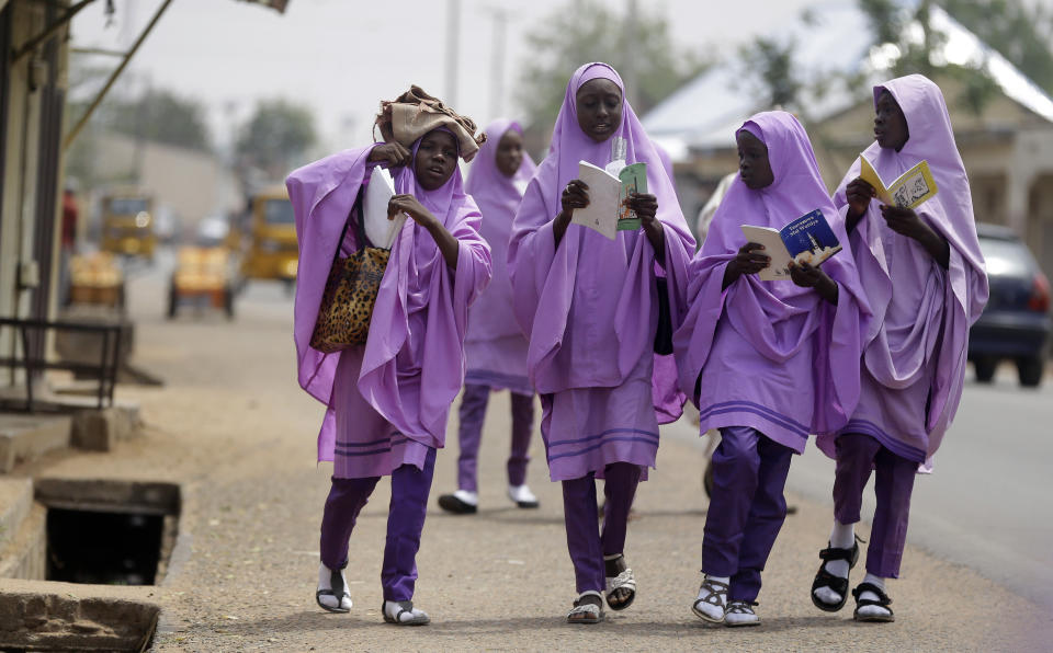 School girls walk on the streets in Yola, Nigeria, Monday Feb. 25, 2019. Official results of Nigeria's presidential election are expected as early as Monday in what is being seen as a close race between Incumbent President Muhammadu Buhari and opposition candidate Atiku Abubakar (AP Photo/Sunday Alamba)